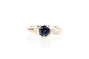 White Gold ring with a blue sapphire on a white background
